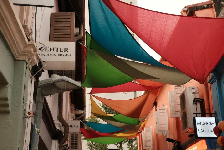 Photo by Jeremy Rubio on Pexels Vibrant colored canopies over a Singapore street, creating an artistic and lively atmosphere.