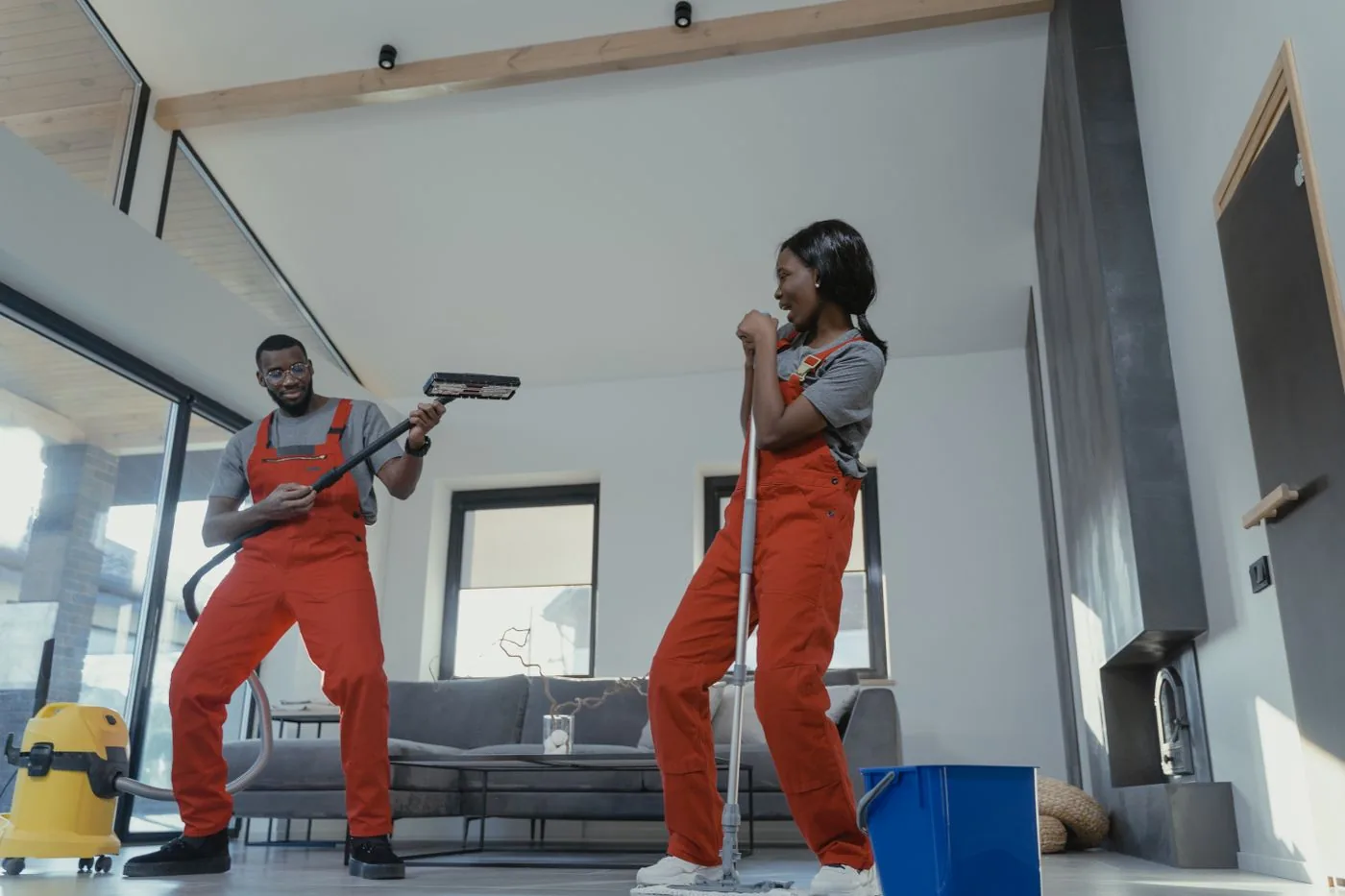 Paving and Driveways — Janitorial team with vacuum and mop in a modern living space