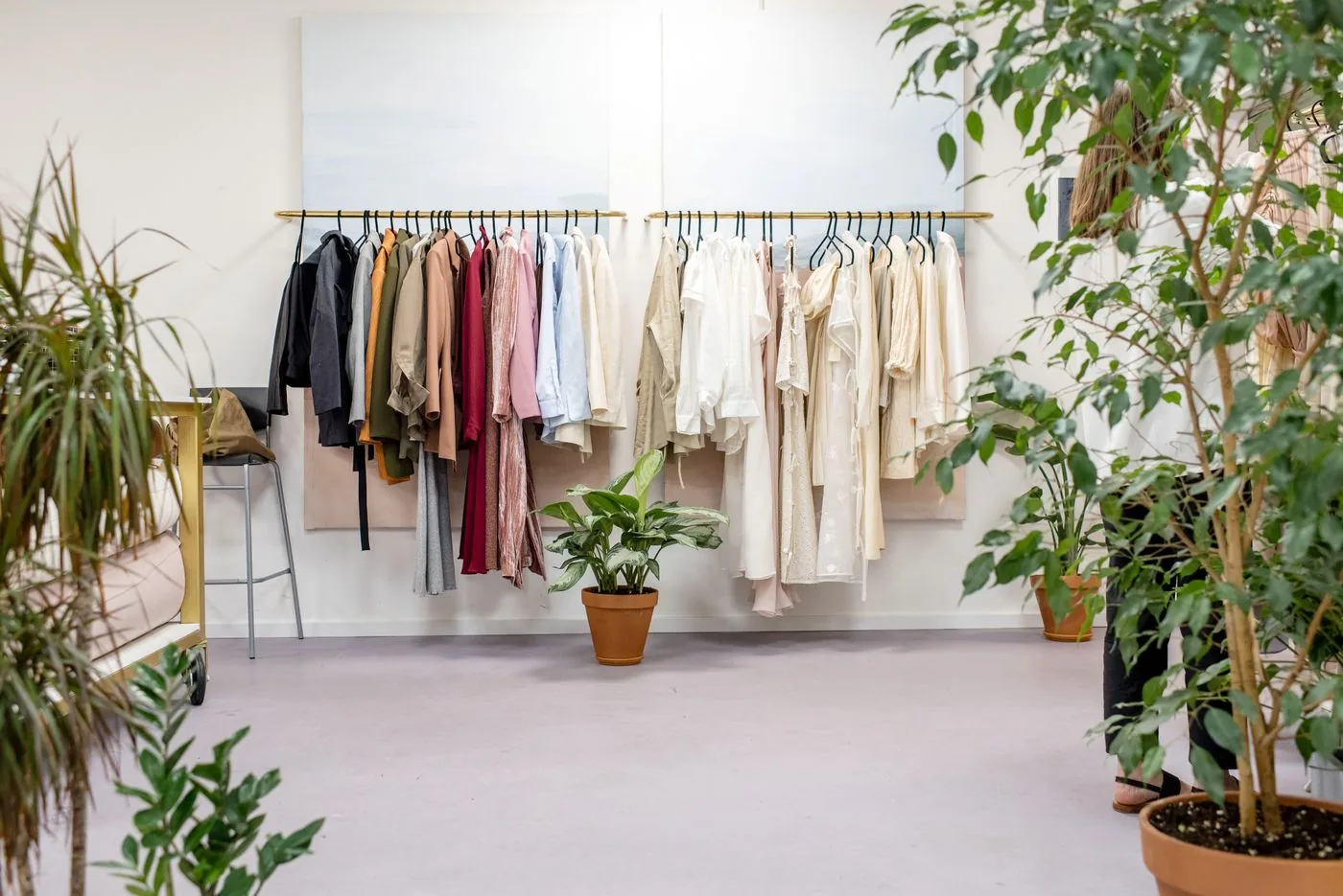 Boutique product showroom with clothing on display rails. Photo by Ksenia Chernaya on Pexels