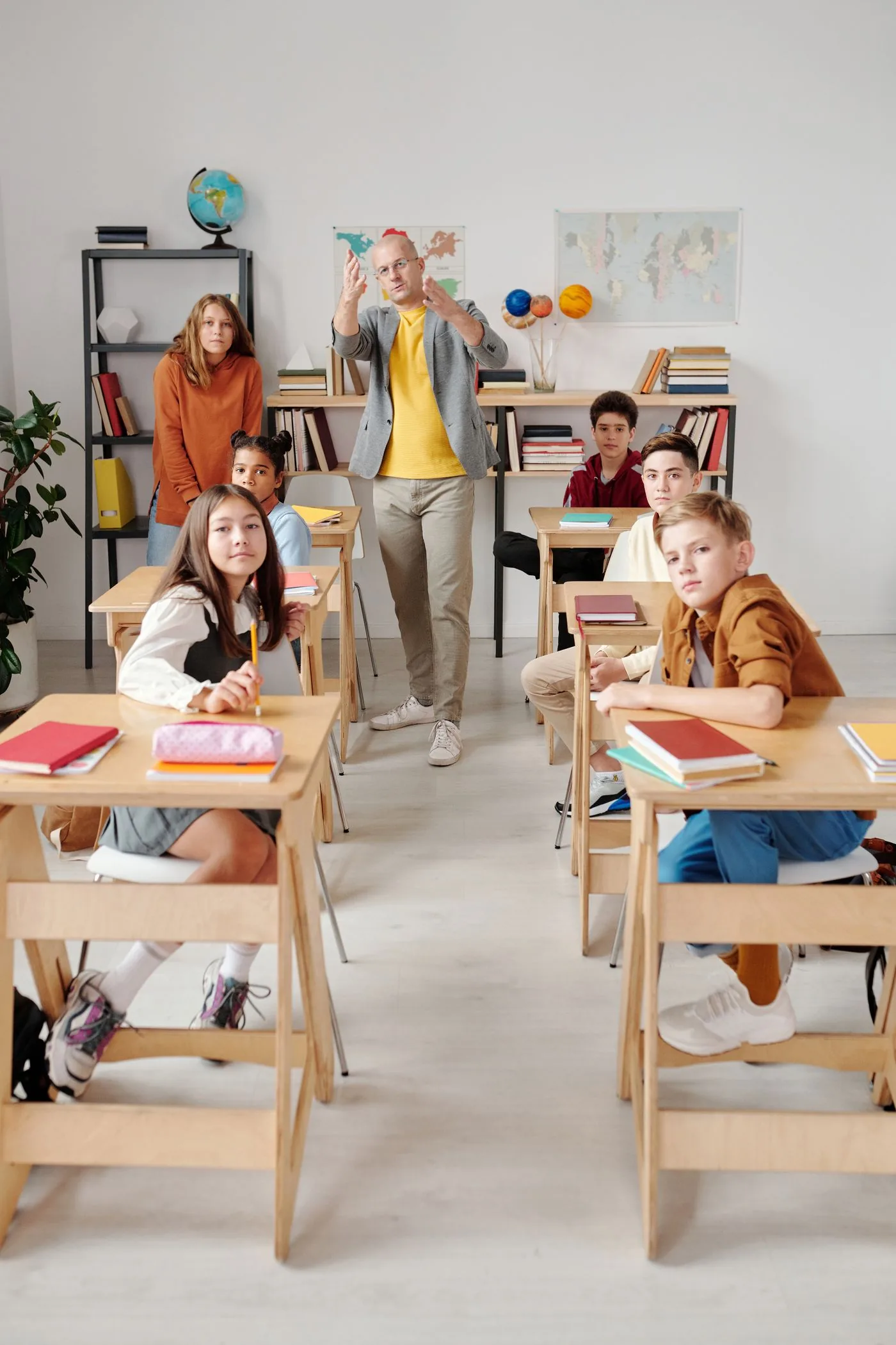Teacher leading an active classroom of successful learners. Photo by Max Fischer on Pexels