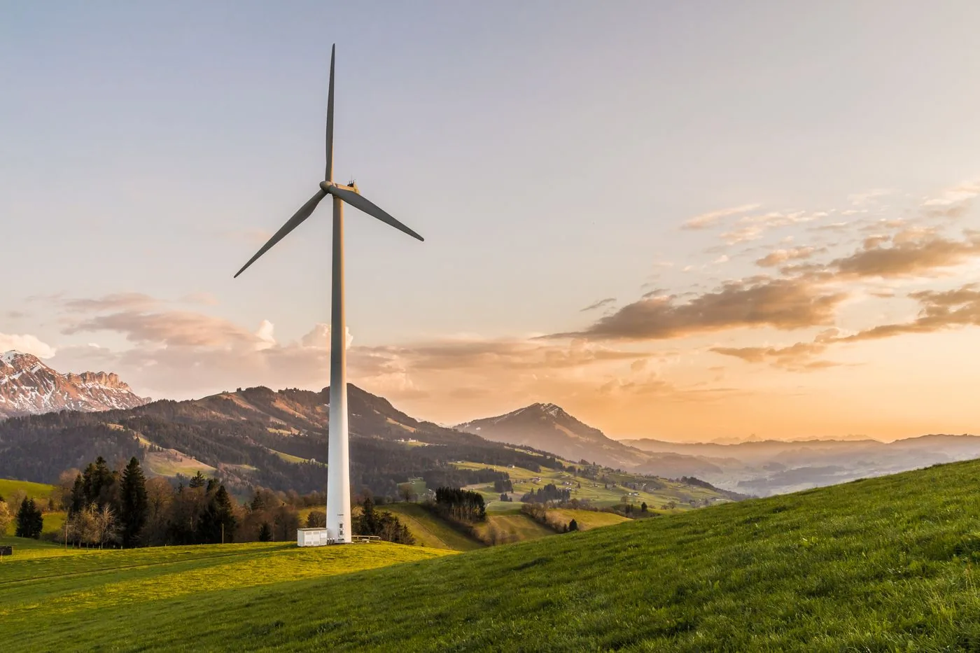 EV Charger Installation — Wind turbine on a hillside representing energy cost and resilience education
