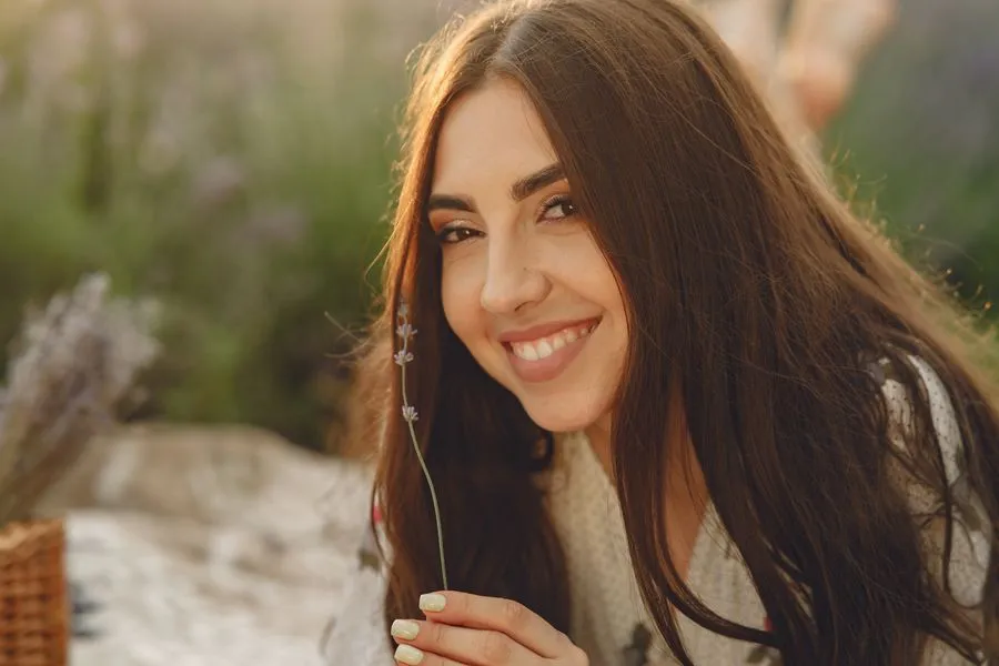 Smiling, healthy woman outdoors. Photo by Gustavo Fring on Pexels