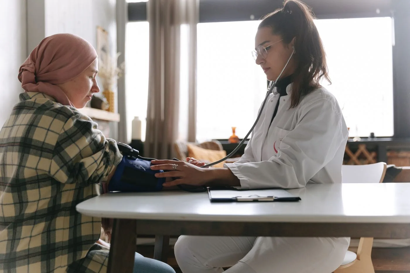 Doctors — Healthcare professional checking a patient blood pressure carefully