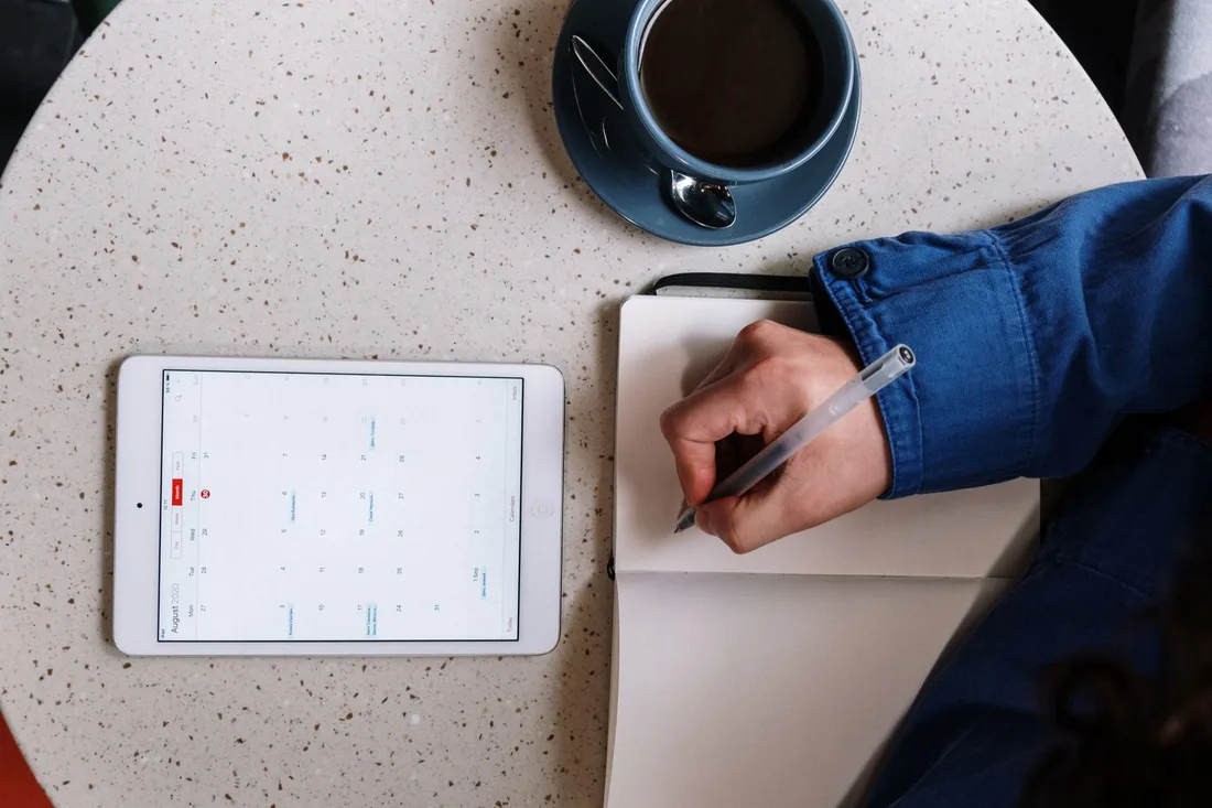 Tablet calendar and notebook used to schedule a booked appointment. Photo by cottonbro studio on Pexels