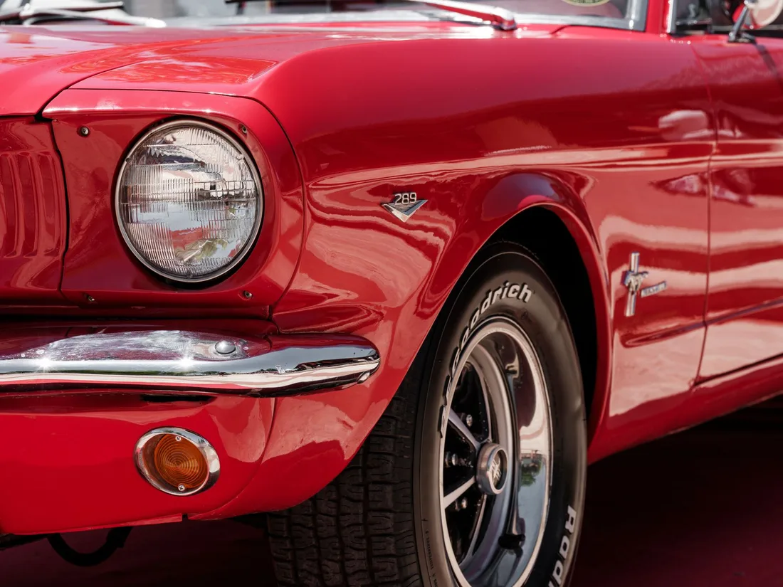 Front of a glossy red classic car with freshly polished paint and chrome. Photo by Engin Akyurt on Pexels
