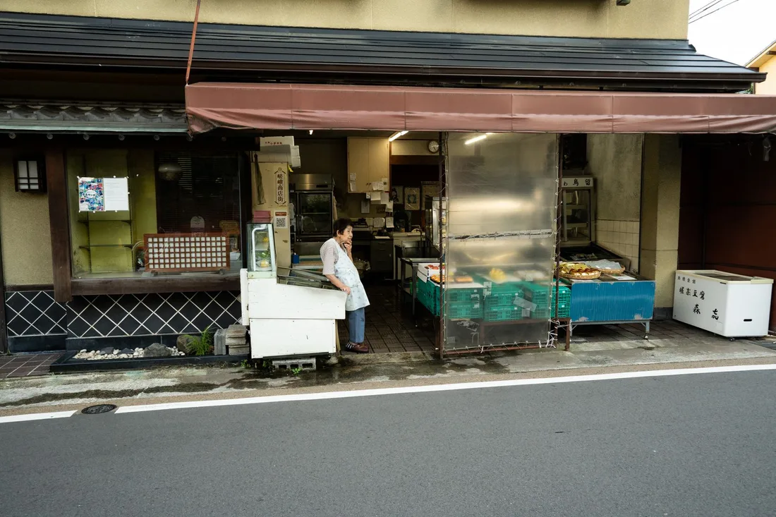 A traditional Kyoto shop with a local vendor standing at the entrance, showcasing Japanese culture. Photo by Emanuele Ricciardi on Pexels