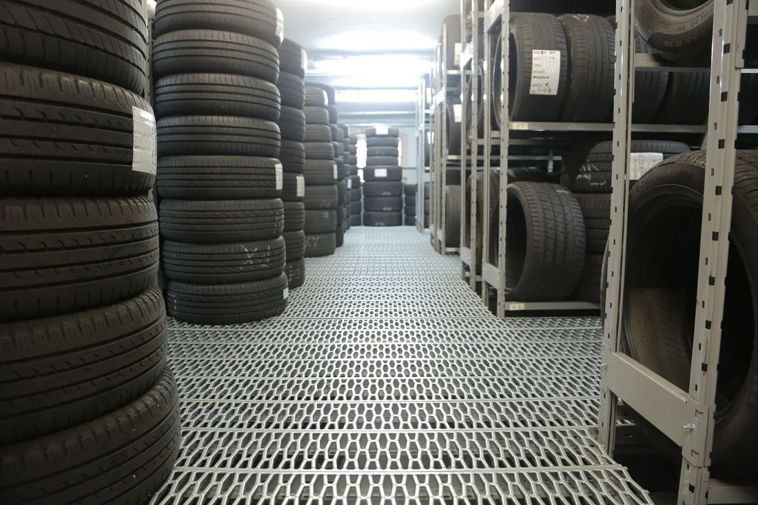 Rows of stacked tires in an indoor industrial warehouse for storage. Photo by Andrea Piacquadio on Pexels