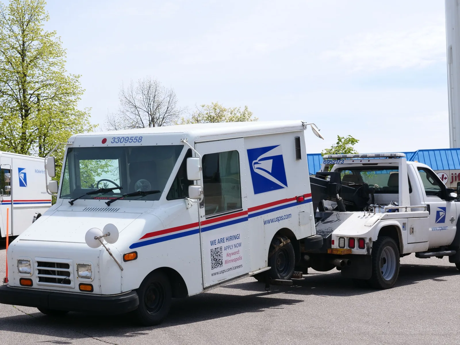 A United States Postal Service (USPS) mail truck is being towed outdoors on a clear day. Photo by Giant Asparagus on Pexels