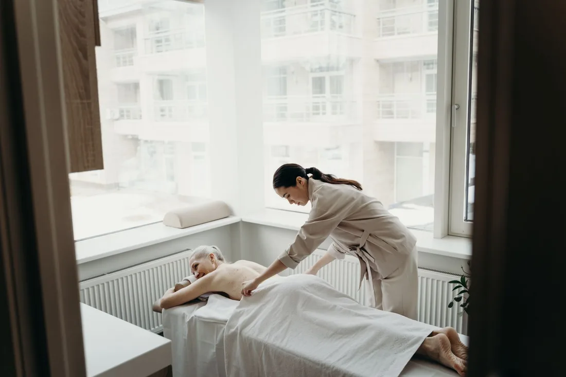 A relaxing spa day with a woman receiving a massage from a therapist indoors. Photo by cottonbro studio on Pexels