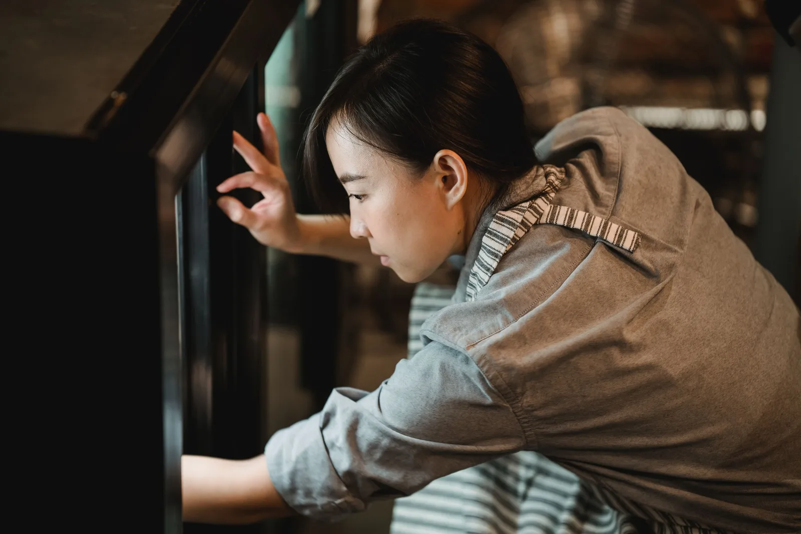 Woman cleaning inside an oven. Photo by Mizuno K on Pexels