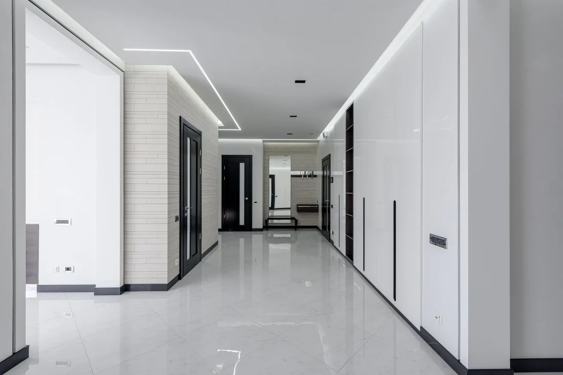 Clean modern apartment corridor with white walls and polished floor. Photo by Max Vakhtbovych on Pexels