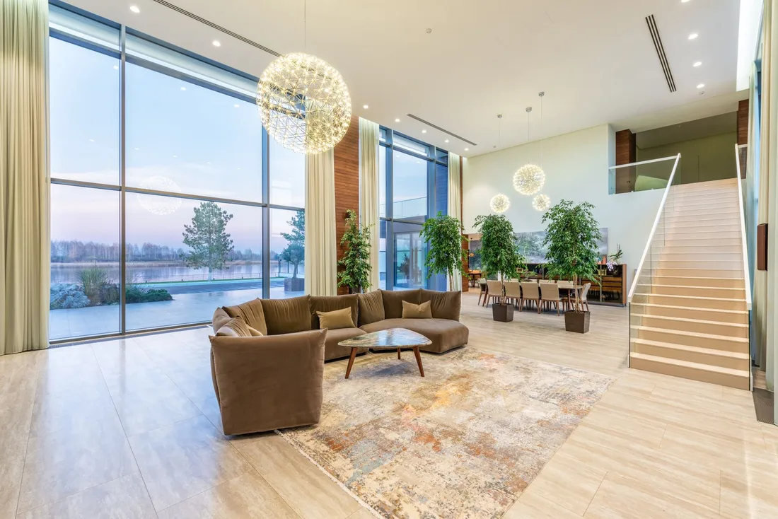 Spotless floor to ceiling glass windows in a bright living room with sofas. Photo by Max Vakhtbovych on Pexels