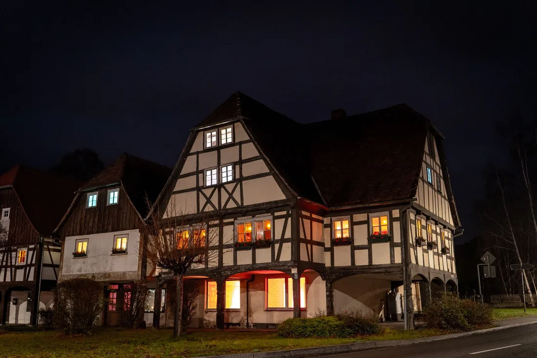 Home with lights on at night during a power cut. Photo by Riedelmax . on Pexels