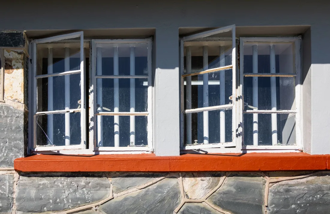 Open white framed windows with red sill on a stone house. Photo by Magda Ehlers on Pexels