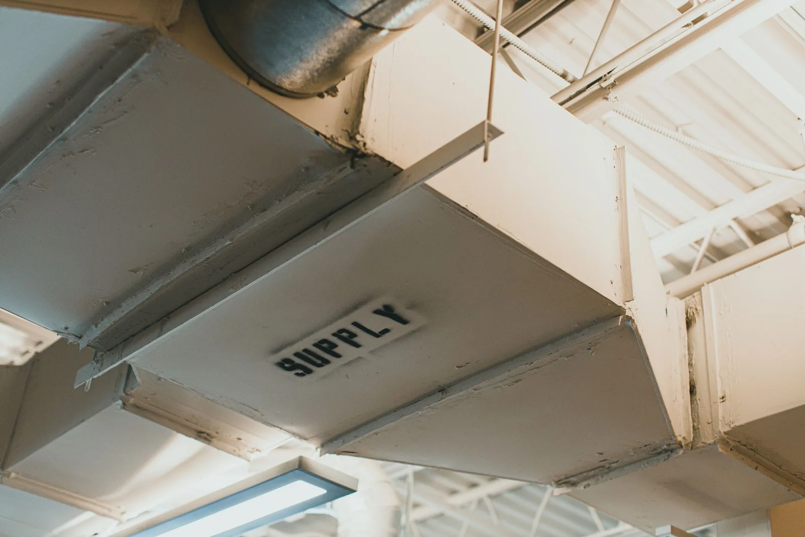 Large ventilation duct run in a ceiling for a ducted heating and cooling system. Photo by Jonathan Cooper on Pexels