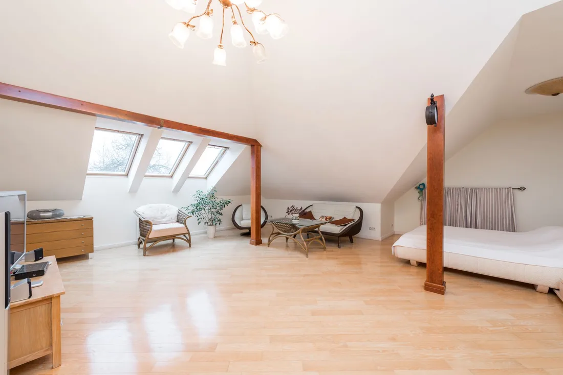 Bright converted attic room with skylights, wood floor and exposed beams. Photo by Max Vakhtbovych on Pexels