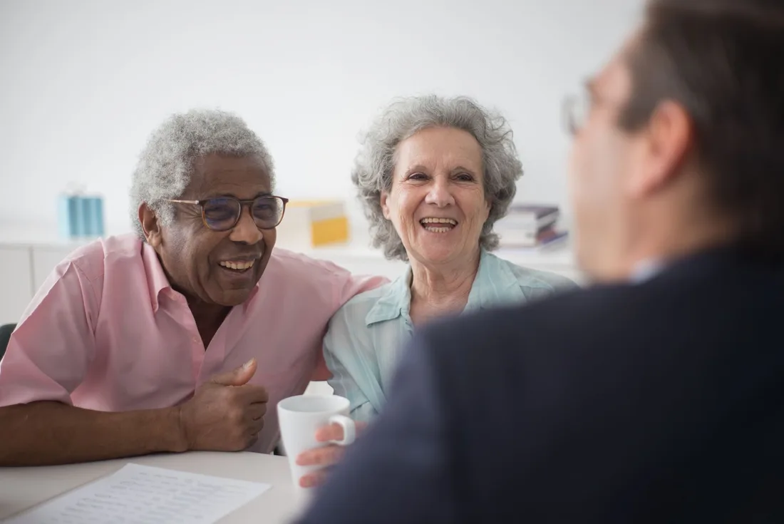 Smiling retired couple meeting with a financial planner at a bright table. Photo by Kampus Production on Pexels