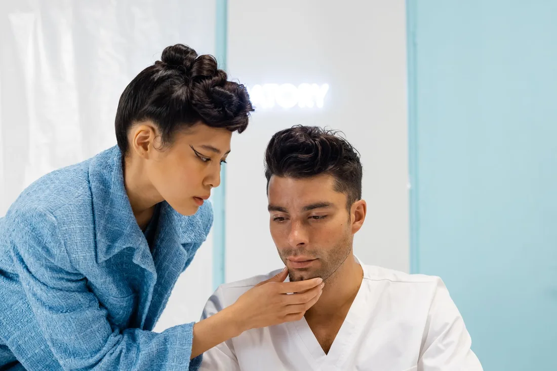 Dermatologist closely checking a man's skin during a bright clinic consultation. Photo by cottonbro studio on Pexels