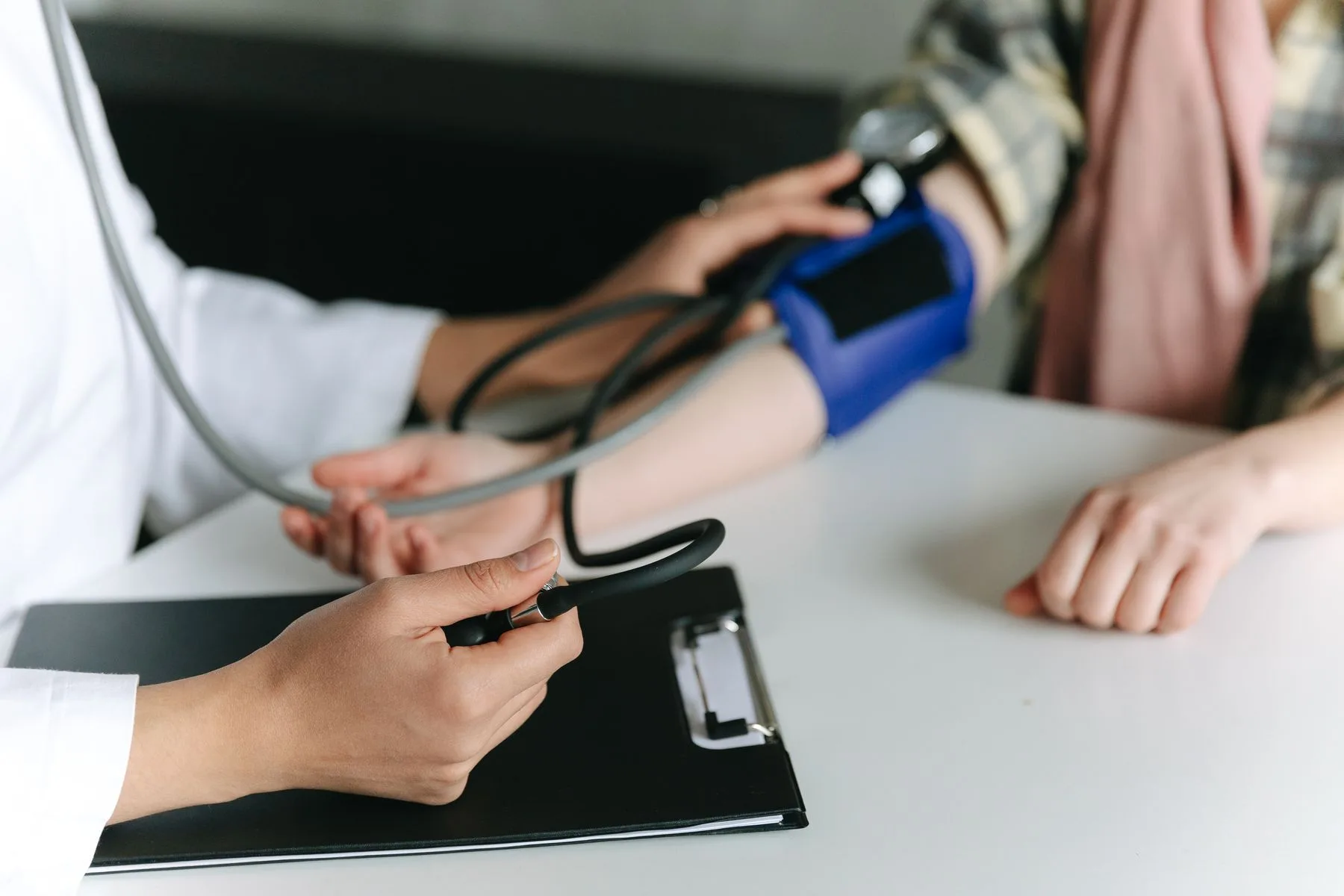 Clinician reviewing long-term health outcomes data. Photo by Thirdman on Pexels