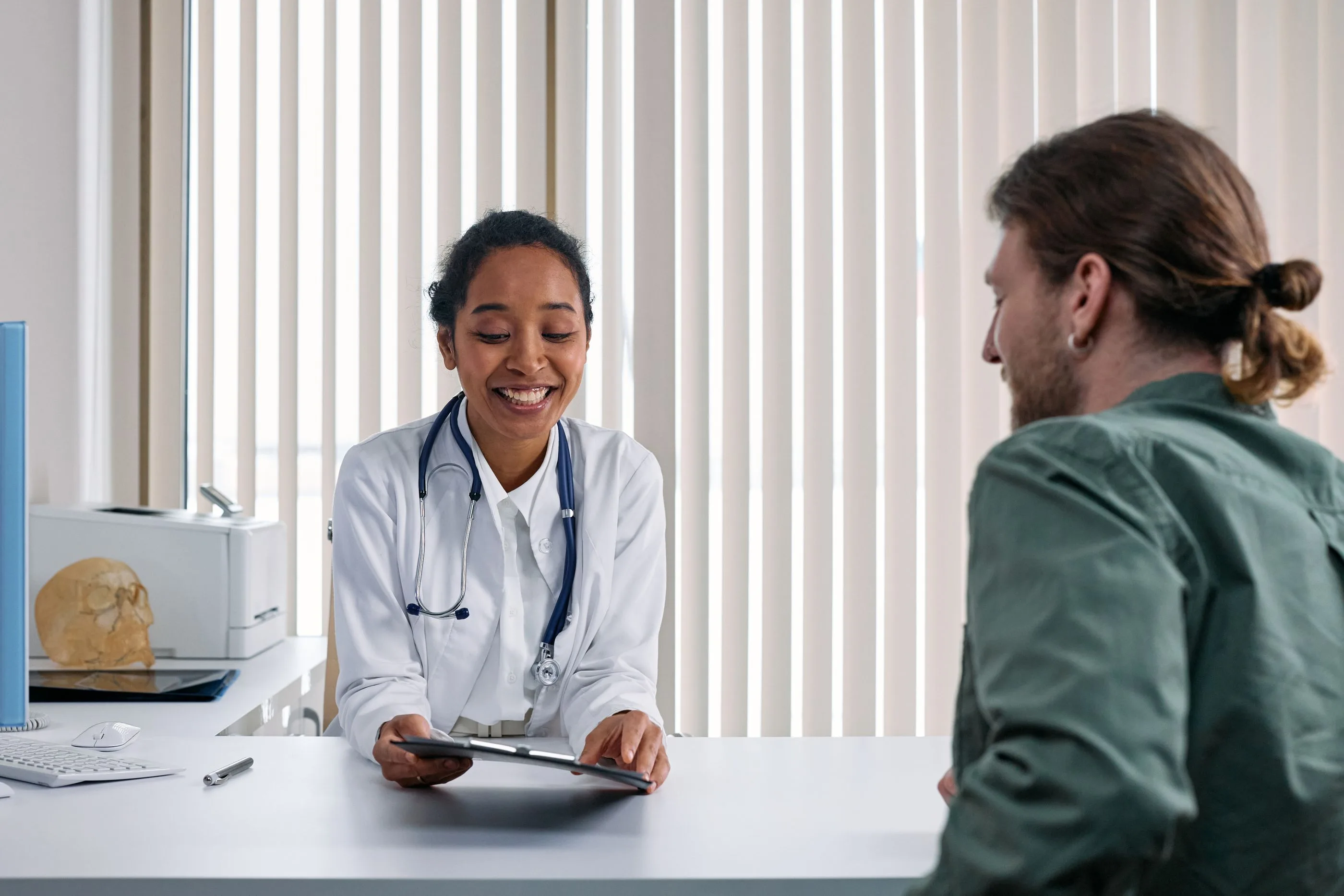 Doctor consulting a patient in a bright clinic. Photo by cottonbro studio on Pexels