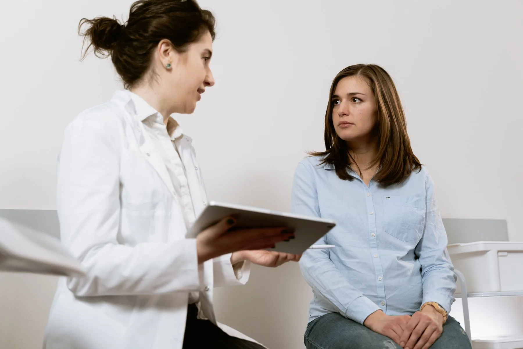 Clinician reviewing treatment options on a tablet. Photo by MART PRODUCTION on Pexels
