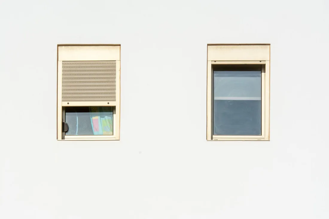A minimalistic facade featuring two modern windows with shutters in a bright, contemporary style. Photo by Jan van der Wolf on Pexels