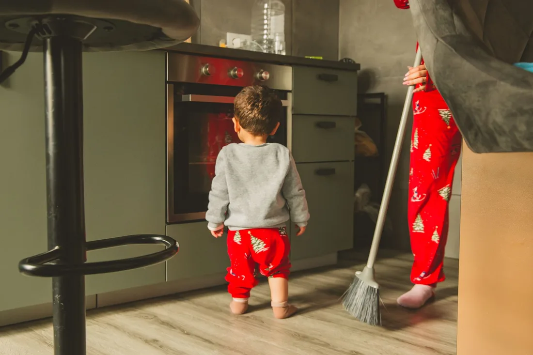 Cute toddler and adult in a kitchen wearing matching Christmas pajamas. Photo by Letícia Fracalossi on Pexels