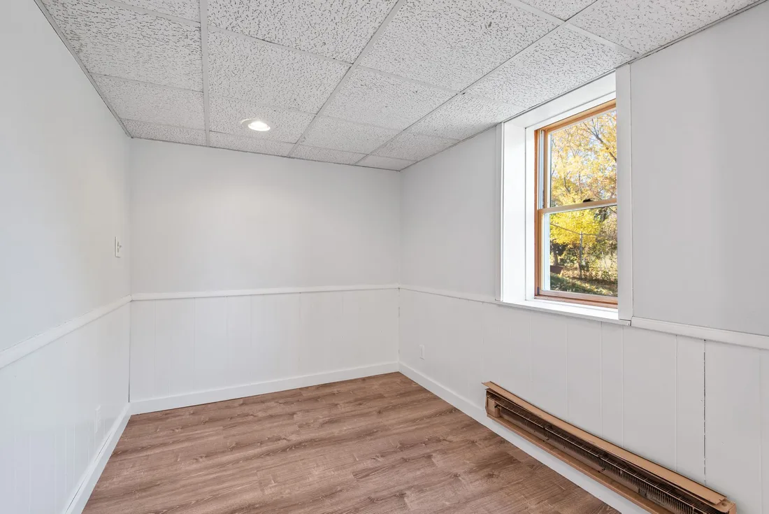 Clean, dry finished basement room with white walls. Photo by Đỗ Huy Hoàng on Pexels
