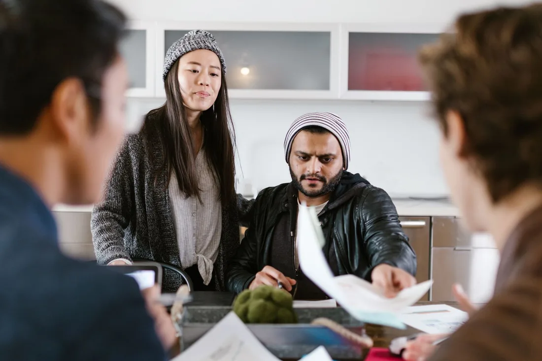 Group of young entrepreneurs brainstorming and collaborating in a modern office setting. Photo by RDNE Stock project on Pexels