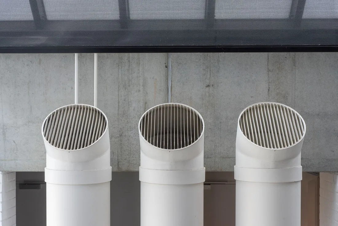 Three clean white ventilation duct outlets mounted on a concrete wall. Photo by Jan van der Wolf on Pexels