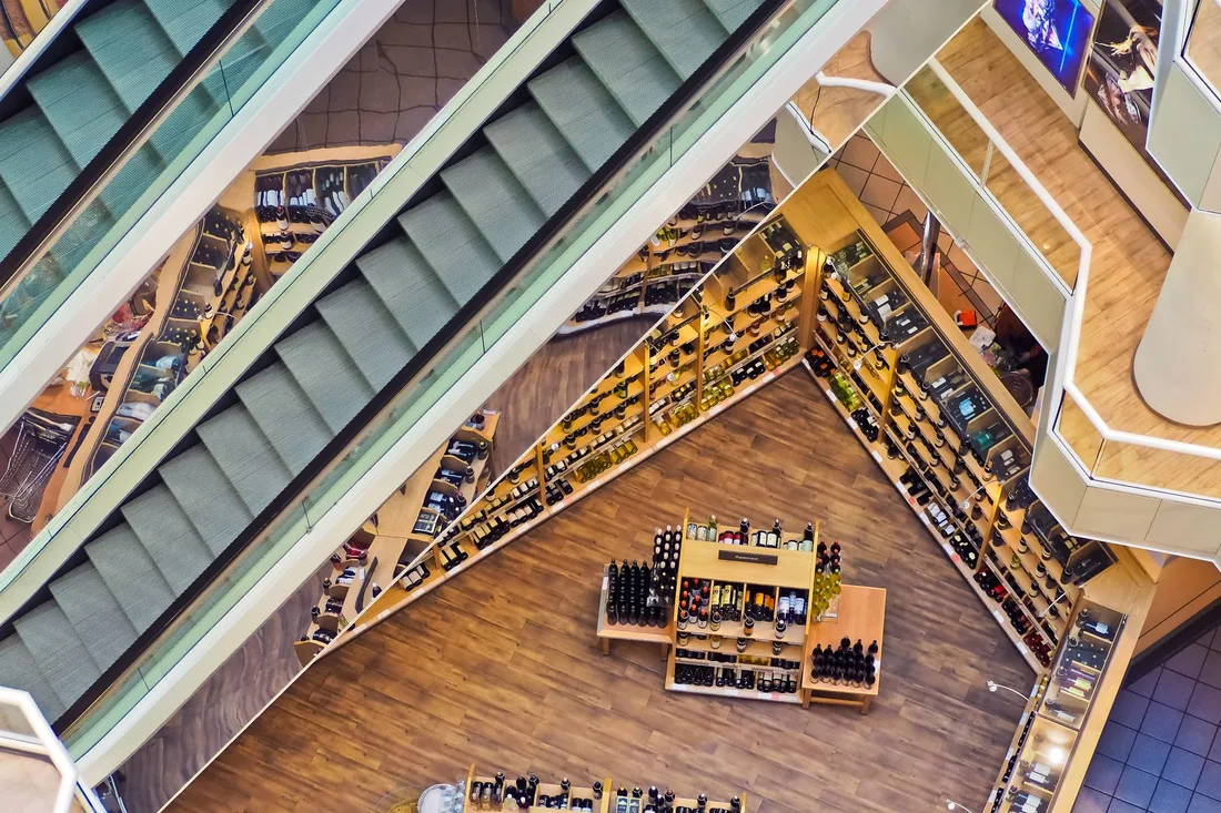 Aerial view of a stylish shopping mall showcasing escalators and well-organized retail displays. Photo by Pixabay on Pexels