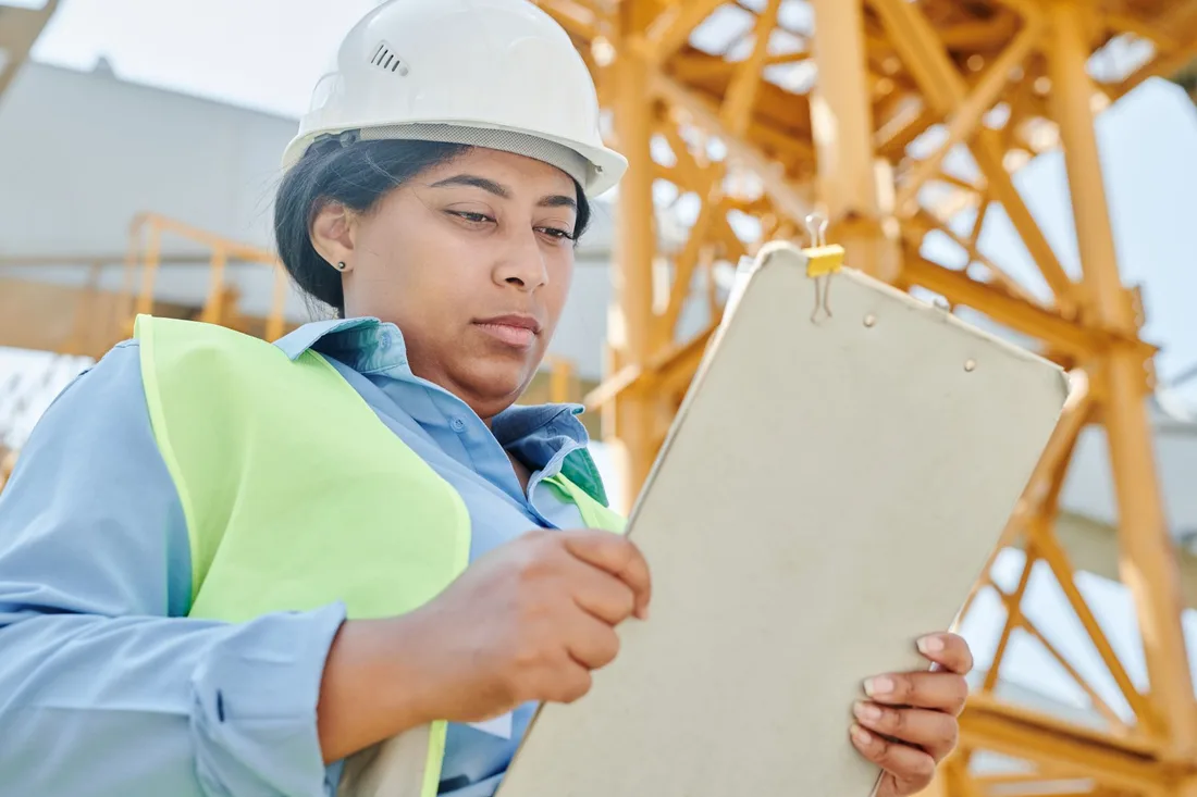 Building inspector with a clipboard assessing a structure on site. Photo by Mikael Blomkvist on Pexels