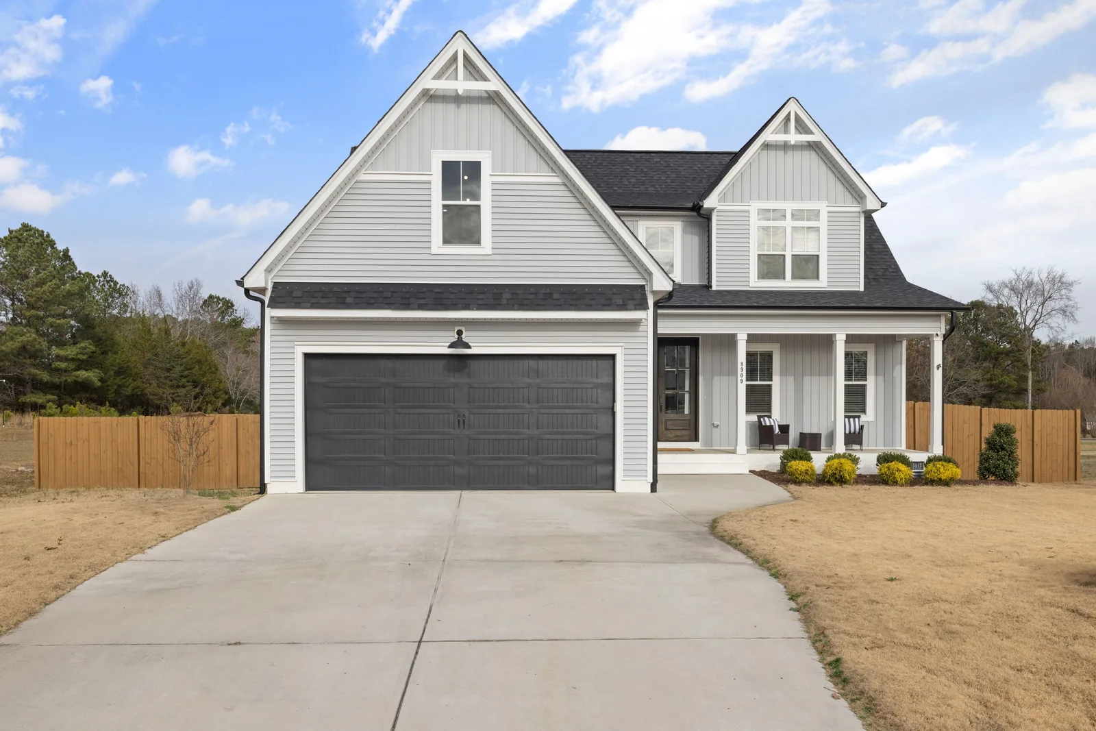 Suburban house with a closed garage door and driveway. Photo by Curtis Adams on Pexels