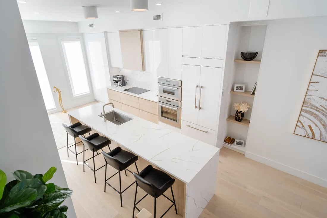 Finished modern kitchen with white island, bar stools and light wood floor. Photo by Ali   Soheil on Pexels
