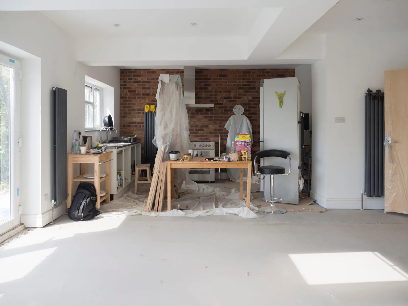 Bright kitchen extension showing renovation work with tools and materials. Photo by Brett Jordan on Pexels