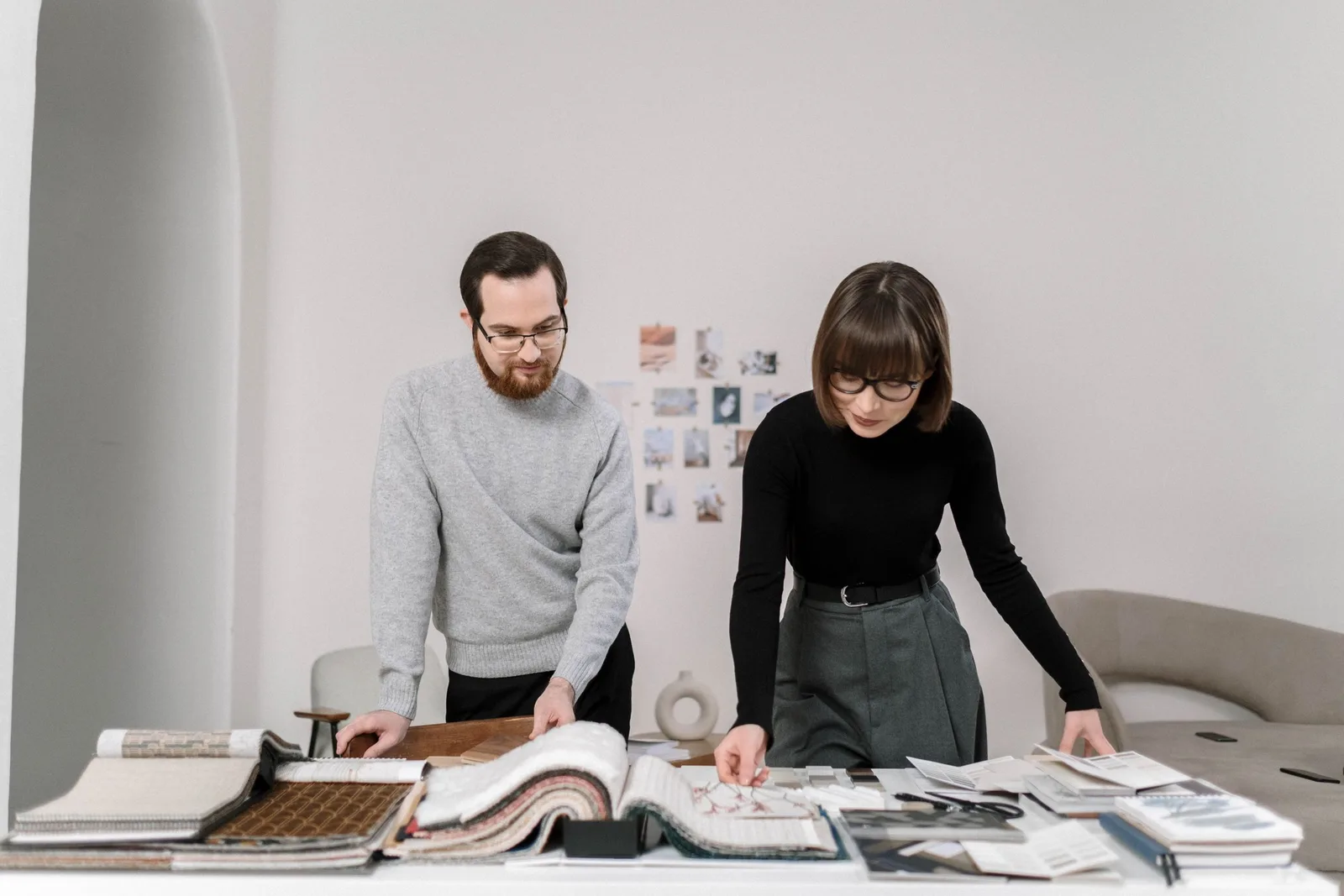 Two interior designers reviewing fabric samples together at a studio table. Photo by cottonbro studio on Pexels