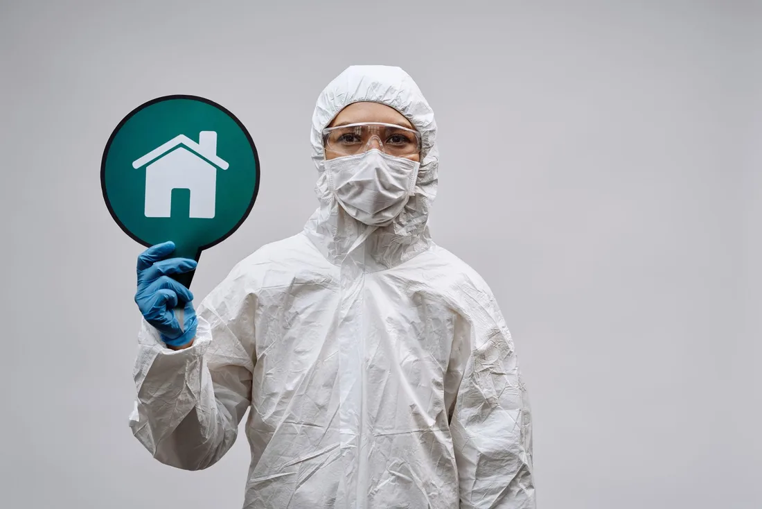 A person in protective gear with a stay safe home symbol, promoting health and safety. Photo by Michelangelo Buonarroti on Pexels