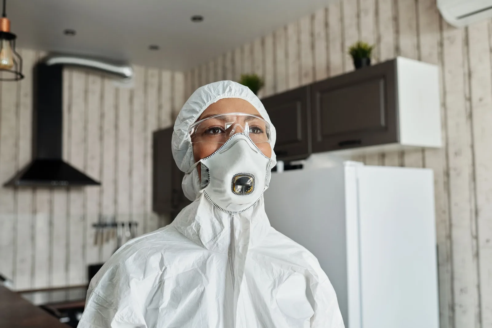 Healthcare professional in full protective suit and mask indoors for safety during pandemic. Photo by Matilda Wormwood on Pexels