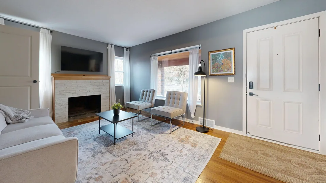 Freshly painted gray living room with a fireplace, sofas and hardwood floor. Photo by Peter  Vang on Pexels