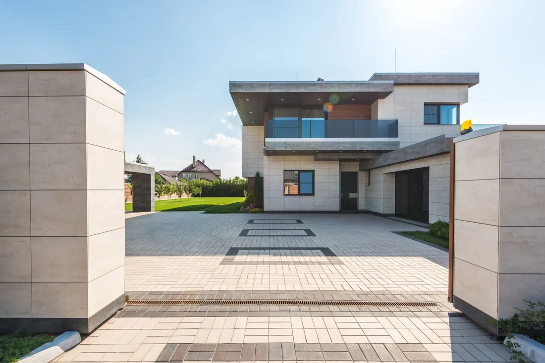 Contemporary two-story luxury home with spacious paved driveway and garden. Photo by Max Vakhtbovych on Pexels