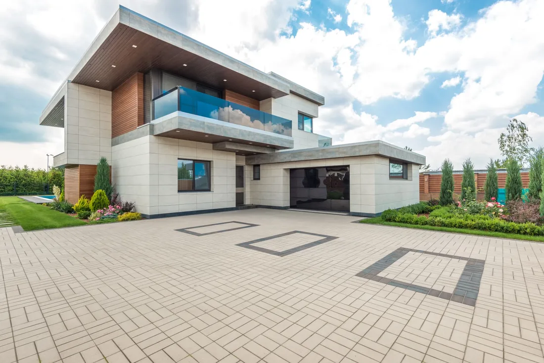 Modern house with a finished block-paved driveway under a blue sky. Photo by Max Vakhtbovych on Pexels