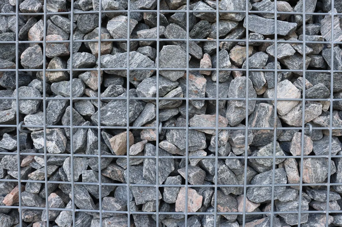Detailed view of a gabion wall filled with natural stones arranged tightly. Photo by Jef KoeleWijn on Pexels