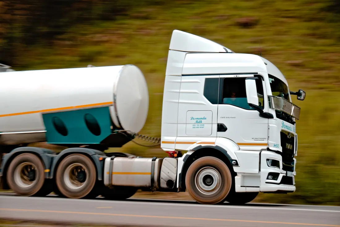 White tanker truck driving on a road with blurred green background. Photo by Linken Van Zyl on Pexels