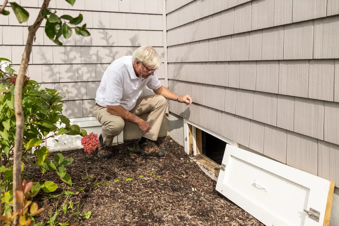 Senior adult inspecting a crawl space entrance during a home inspection on a sunny day. Photo by Kathleen Austin Kuhn on Pexels