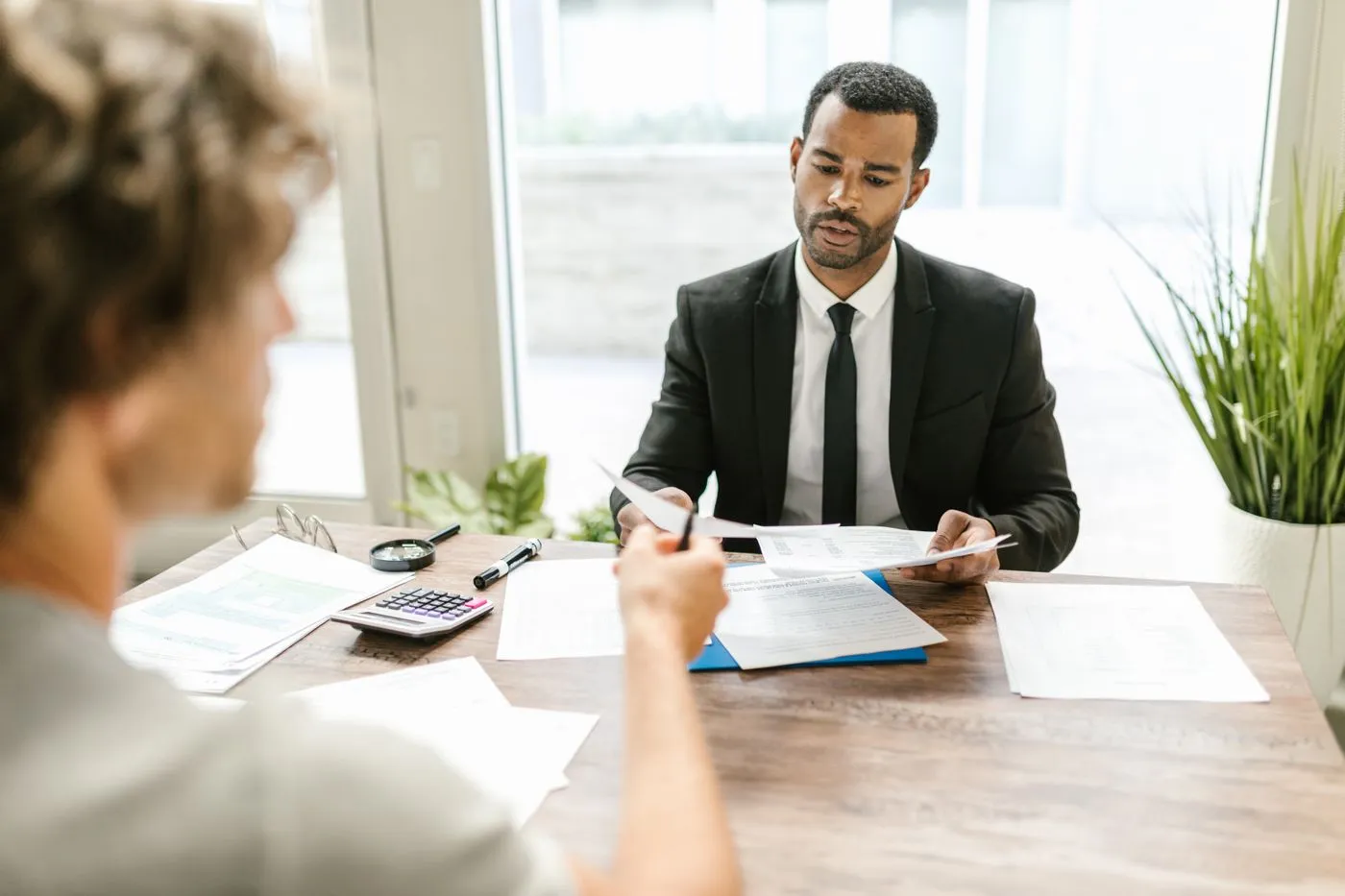 Financial advisor meeting a client at a table. Photo by RDNE Stock project on Pexels
