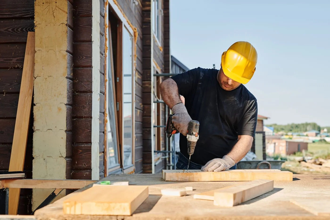 Tradesman in a hard hat working on a house. Photo by Mikael Blomkvist on Pexels
