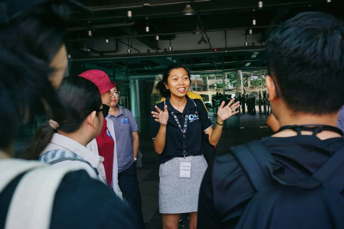Tour guide leading a group of travellers. Photo by Mico Medel on Pexels