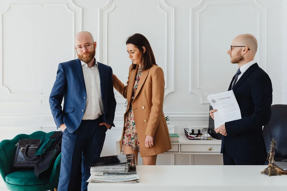 Lawyer reviewing documents with a woman client in a bright law office. Photo by https://kaboompics.com/ on Pexels