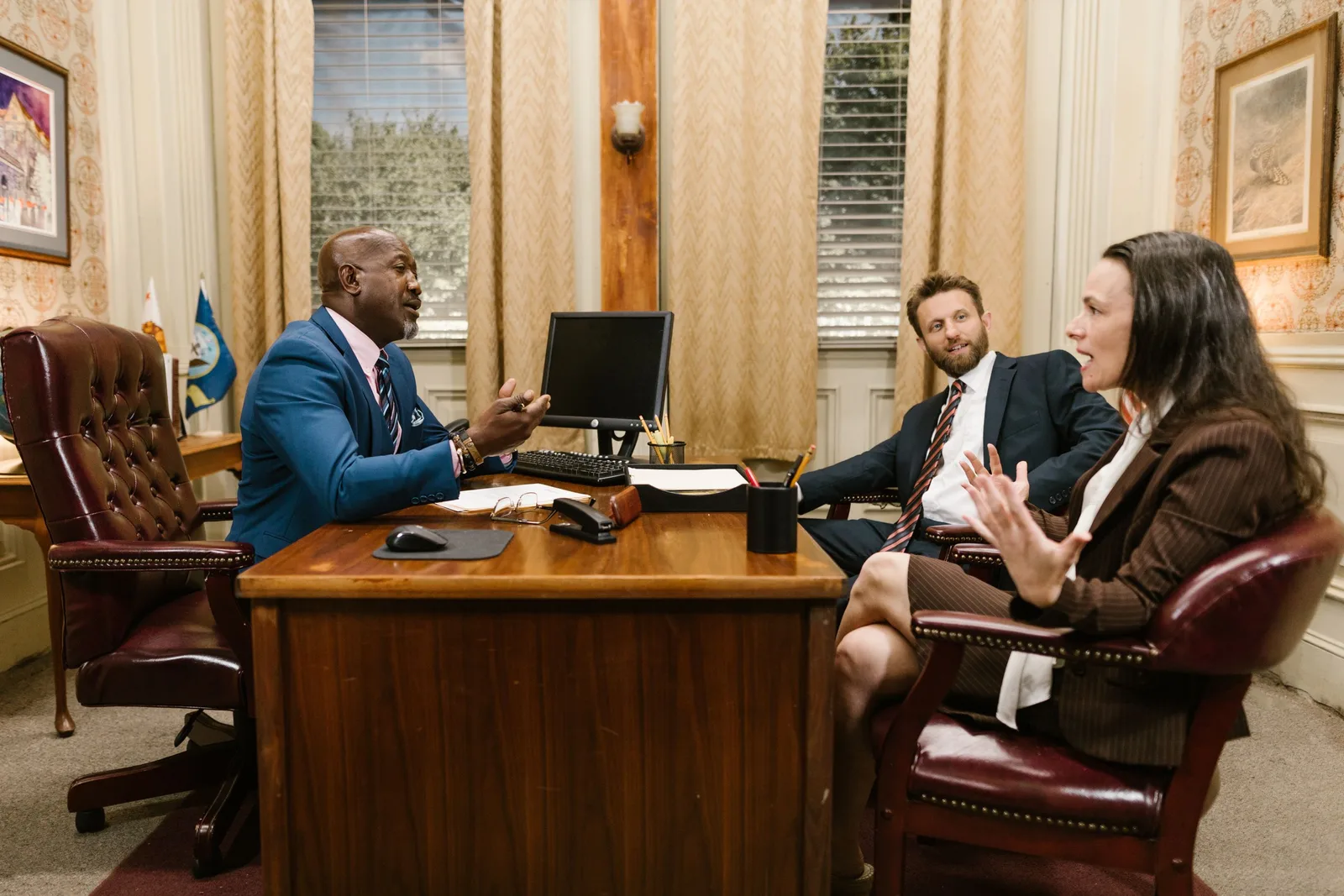 Personal injury lawyer meeting a client in a wood-panelled office. Photo by RDNE Stock project on Pexels