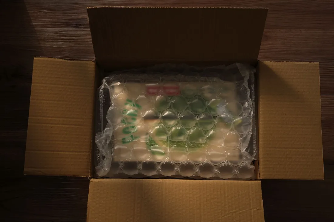Open cardboard box displaying bubble-wrapped content, photographed indoors with soft lighting.. Photo by Sue Hsu on Pexels